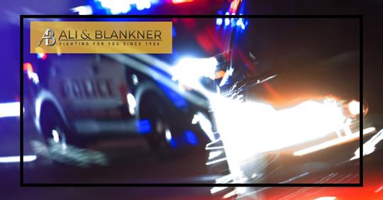 police car pulling over vehicle at night